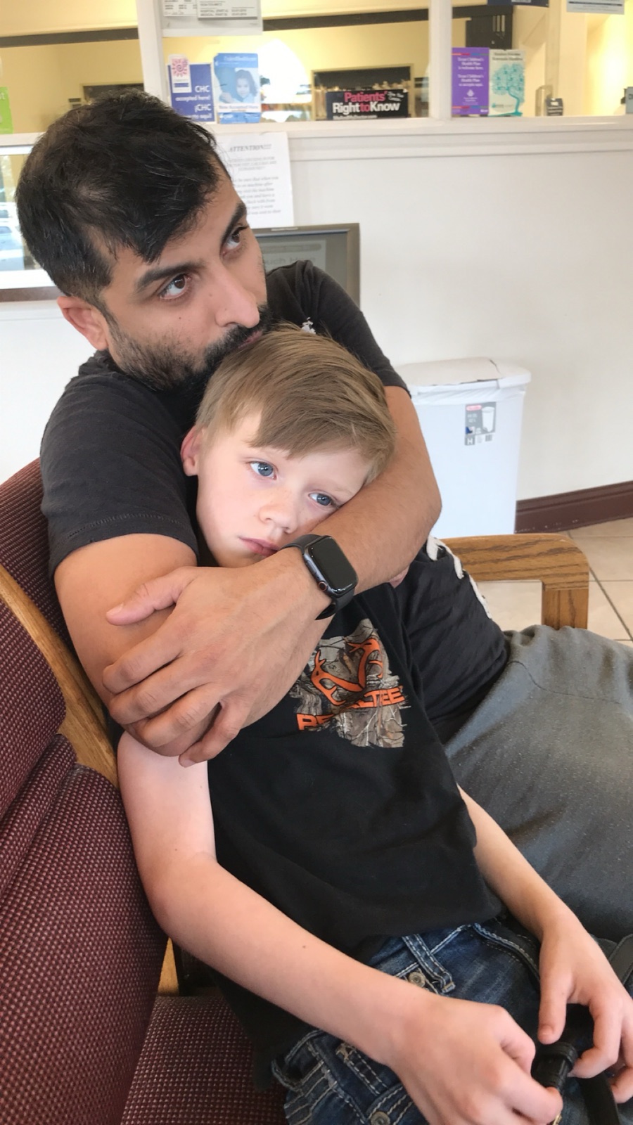 Sohail holding one of his sons close